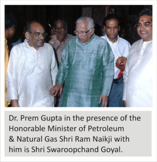 Dr. Prem Gupta in the presence of the Honorable Minister of Petroleum & Natural Gas Shri Ram Naikji with him is Shri Swaroopchand Goyal