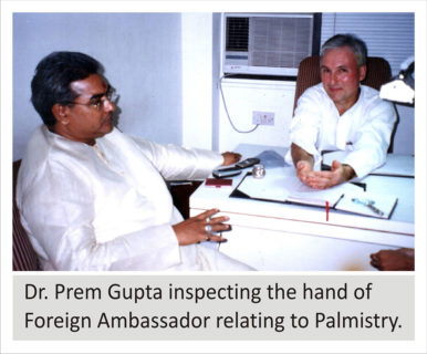 Dr. Prem Gupta inspecting hand of Foreign Ambassador relating to Palmistry